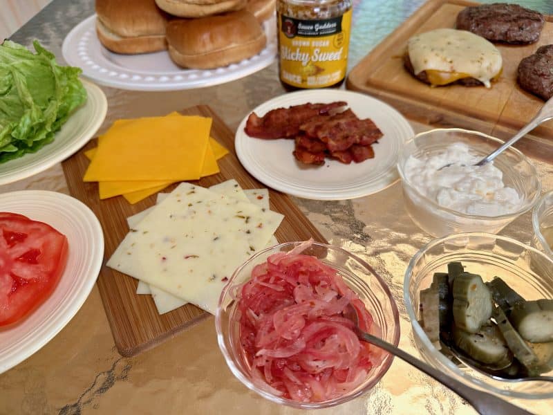 a table full of selections for a gourmet burger bar