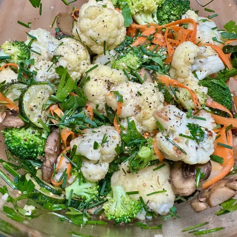 Bowl full of Dressed Veggies And Herbs