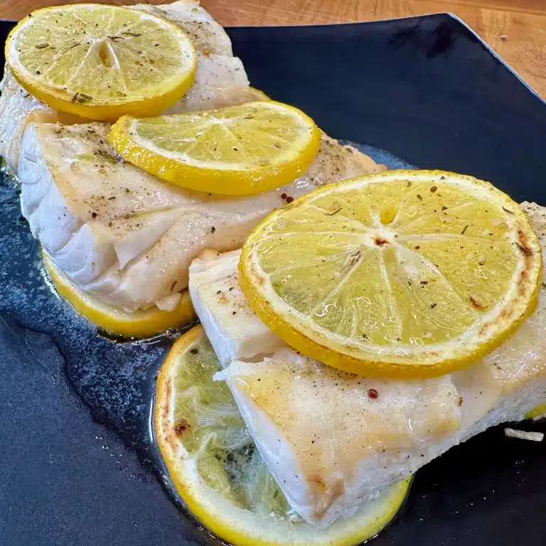 Fish With Lemon on a black plate